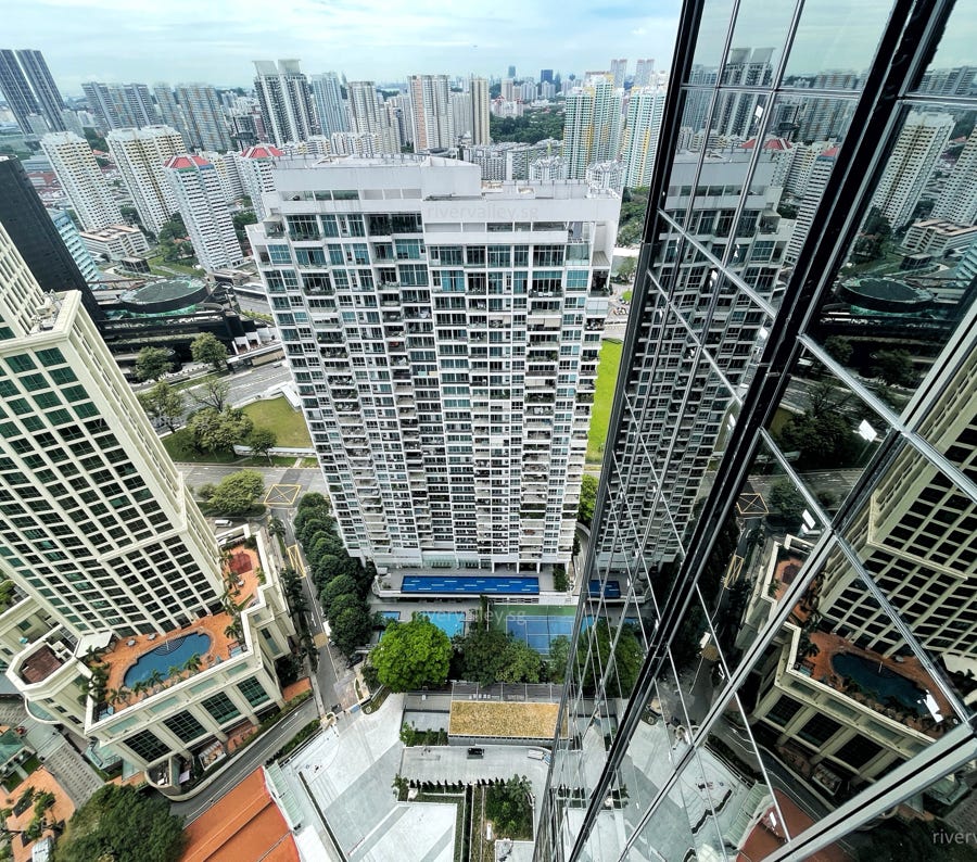 Stunning aerial view showcasing a modern architectural complex surrounded by vibrant greenery and winding roads.